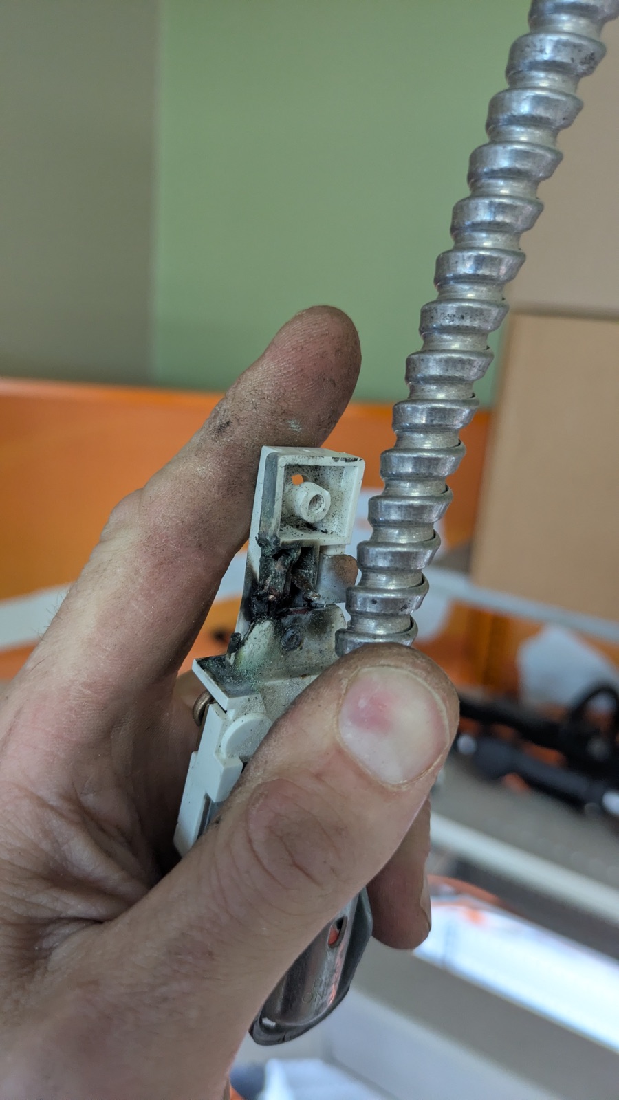 A heat-damaged electrical fitting, the kind of failure that follows an overloaded or aging connection