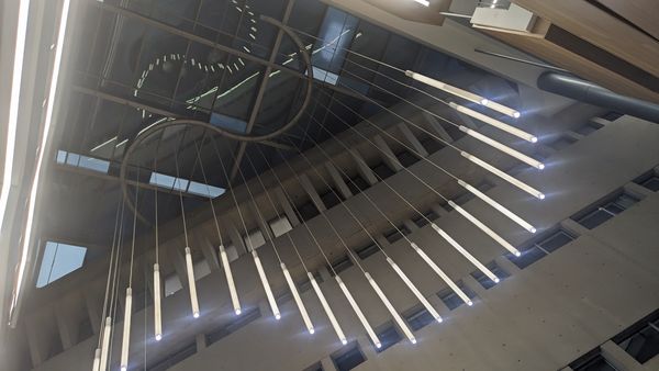 Cascading cylinder pendant lights in a multi-story commercial atrium