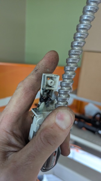 Burned and failed electrical fitting found during a repair