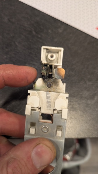 Close-up of a burned electrical device removed during a repair