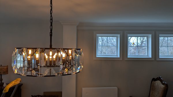 Round crystal chandelier installed in a dining room