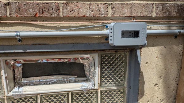 Weatherproof GFCI outlet installed on an exterior wall