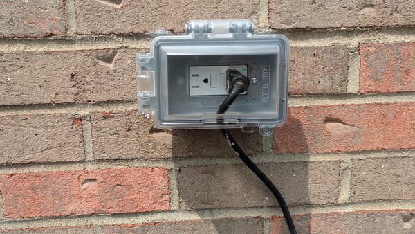 Exterior outlet on brick with a weatherproof in-use cover