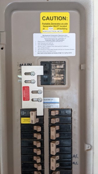 Electrical panel fitted with a generator interlock kit and labeling