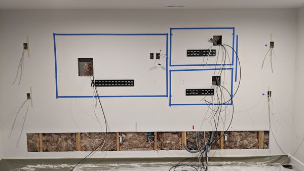 Electrical rough-in and wiring laid out for a media wall
