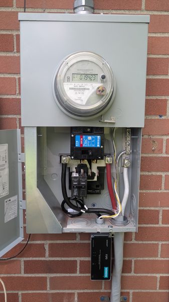 Exterior meter-main combination panel on a brick wall