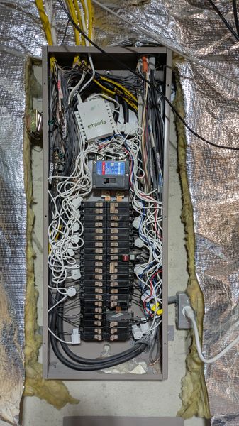 Residential electrical panel with a whole-home energy monitor installed