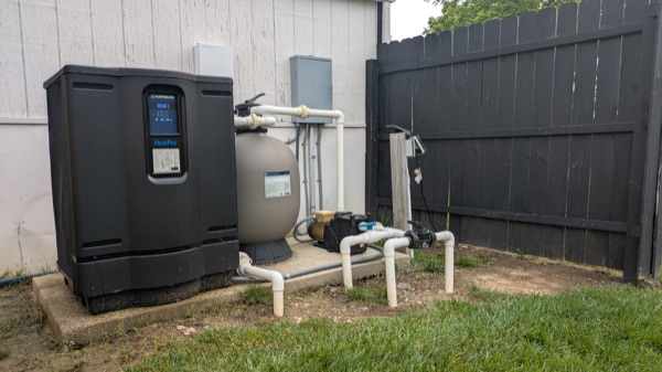 Pool equipment pad with heat pump, filter, and pump wiring