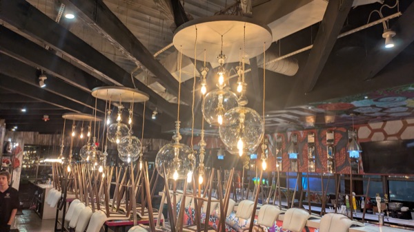 Cluster of glass-globe pendant lights over restaurant seating