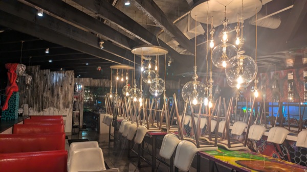 Feature pendant lighting installed over restaurant booths