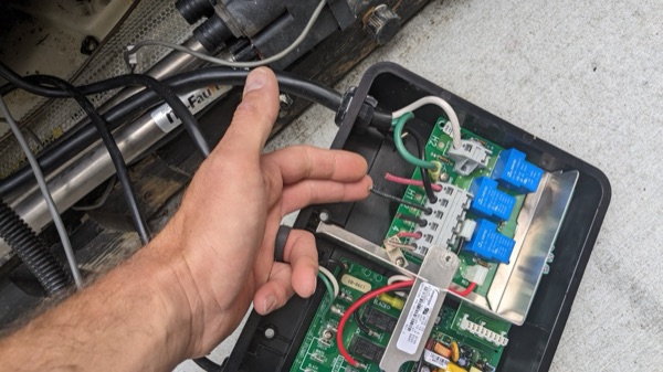 Spa control board and wiring being serviced by an electrician