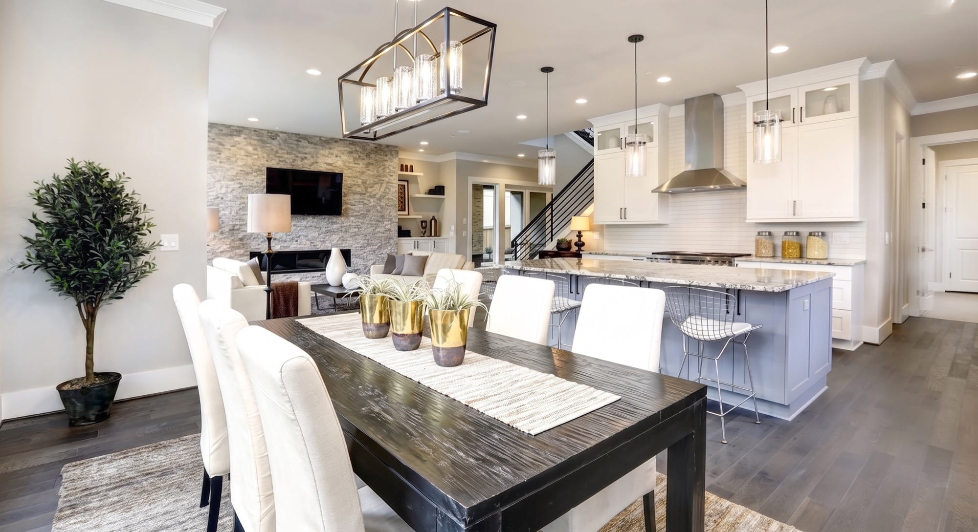 Bright open-concept kitchen and dining room with custom lighting by Benrishi Electrical