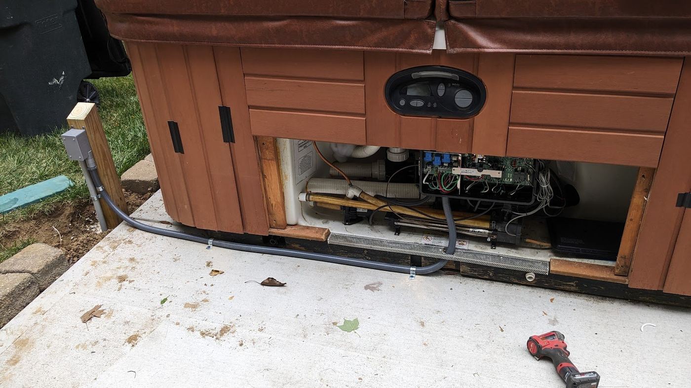 Benrishi Electrical hot tub installation showing weatherproof disconnect and conduit running to spa equipment bay